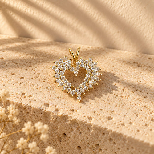 Open Offer Double Row gold open-heart pendant on a travertine ledge