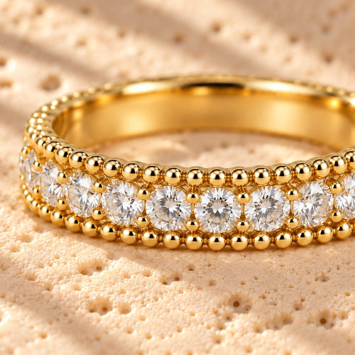 White Tie macro close-up: single row of prong-set clear stones between two rows of tiny gold beads