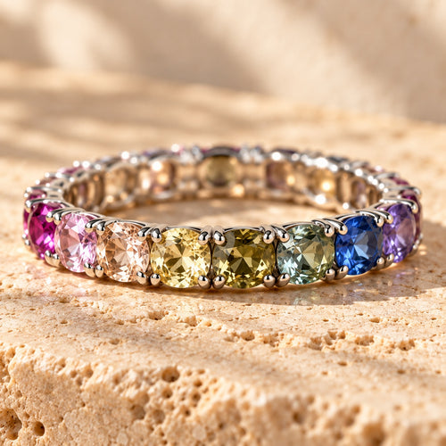 Full Spectrum eternity ring macro showing the cushion-cut rainbow stones and prong settings