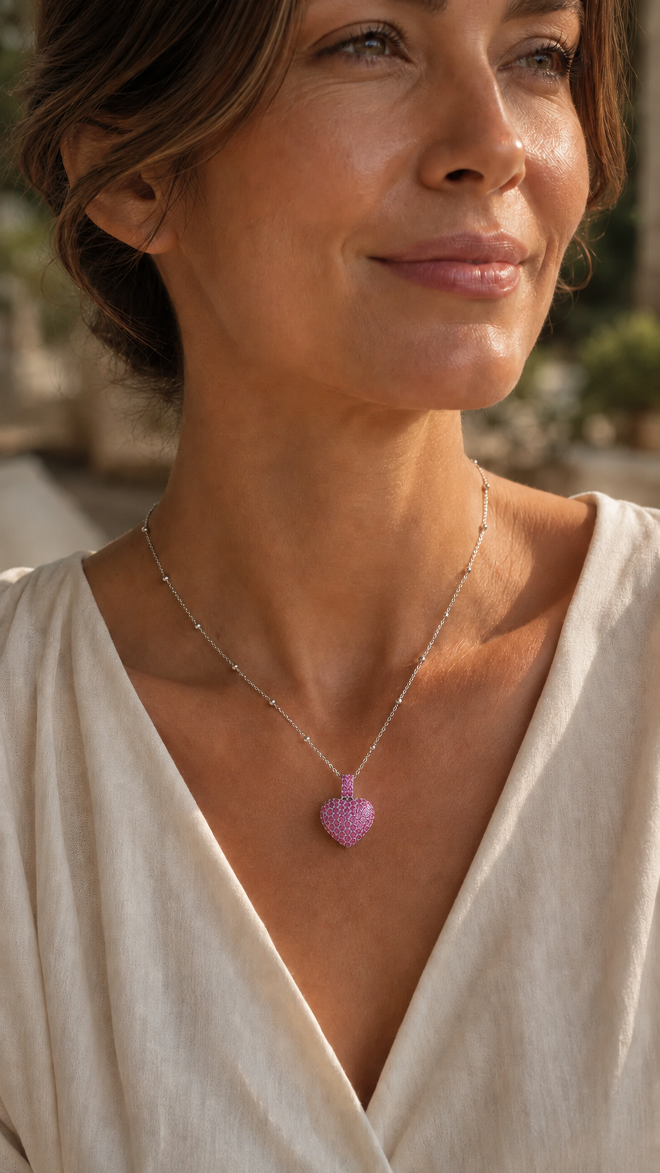 Be Still My Heart pink heart pendant worn on model at accurate scale