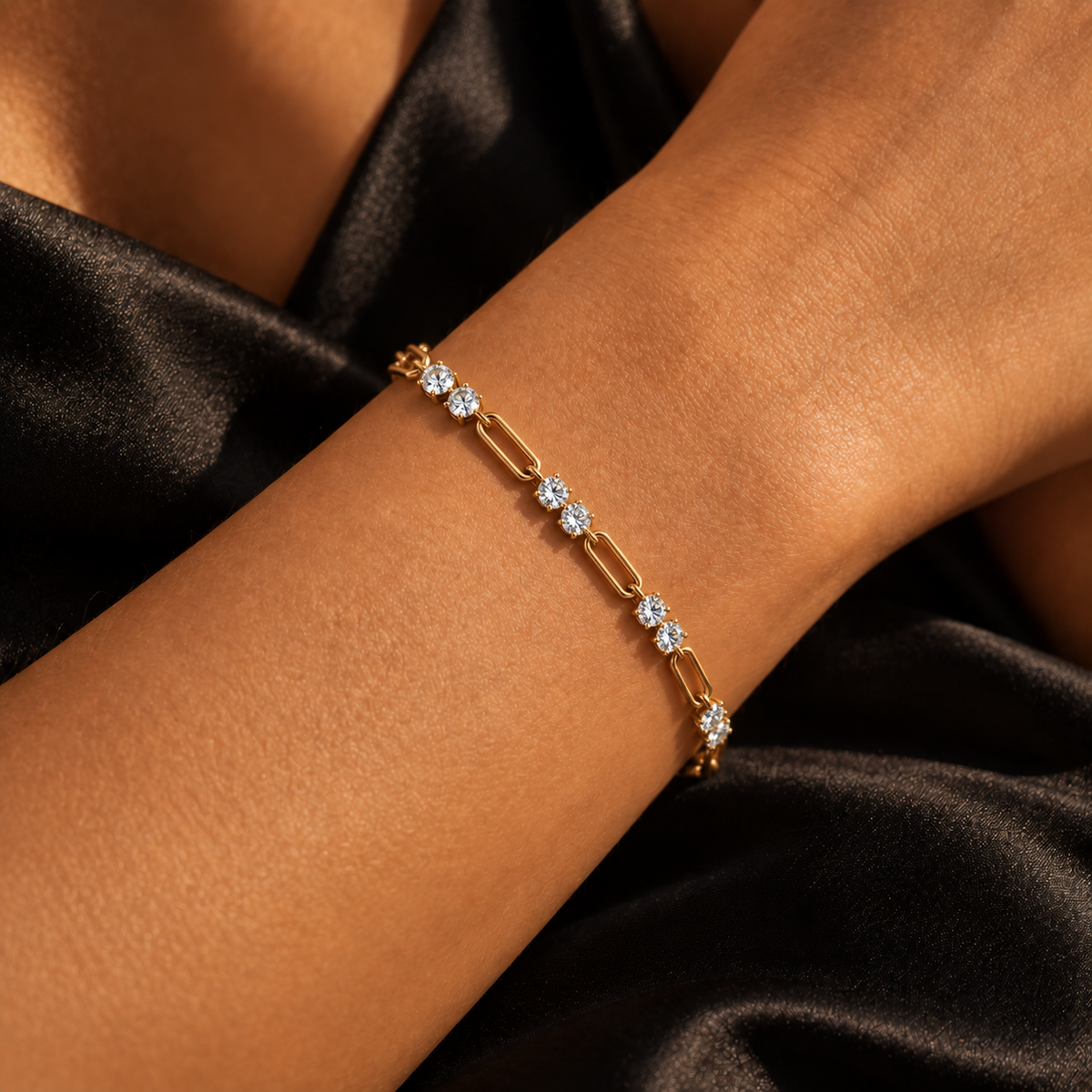 Chain Reaction gold link bracelet worn on model