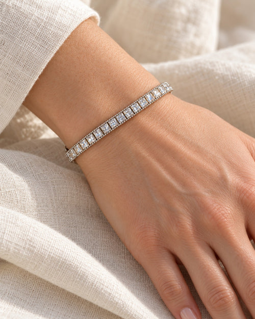 Fair and Square tennis bracelet on the wrist — square princess-cut stones with a beaded edge