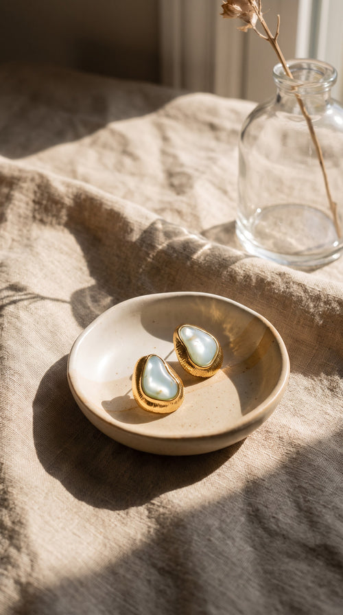 Organic Glow blue earrings styled in a ceramic dish on linen