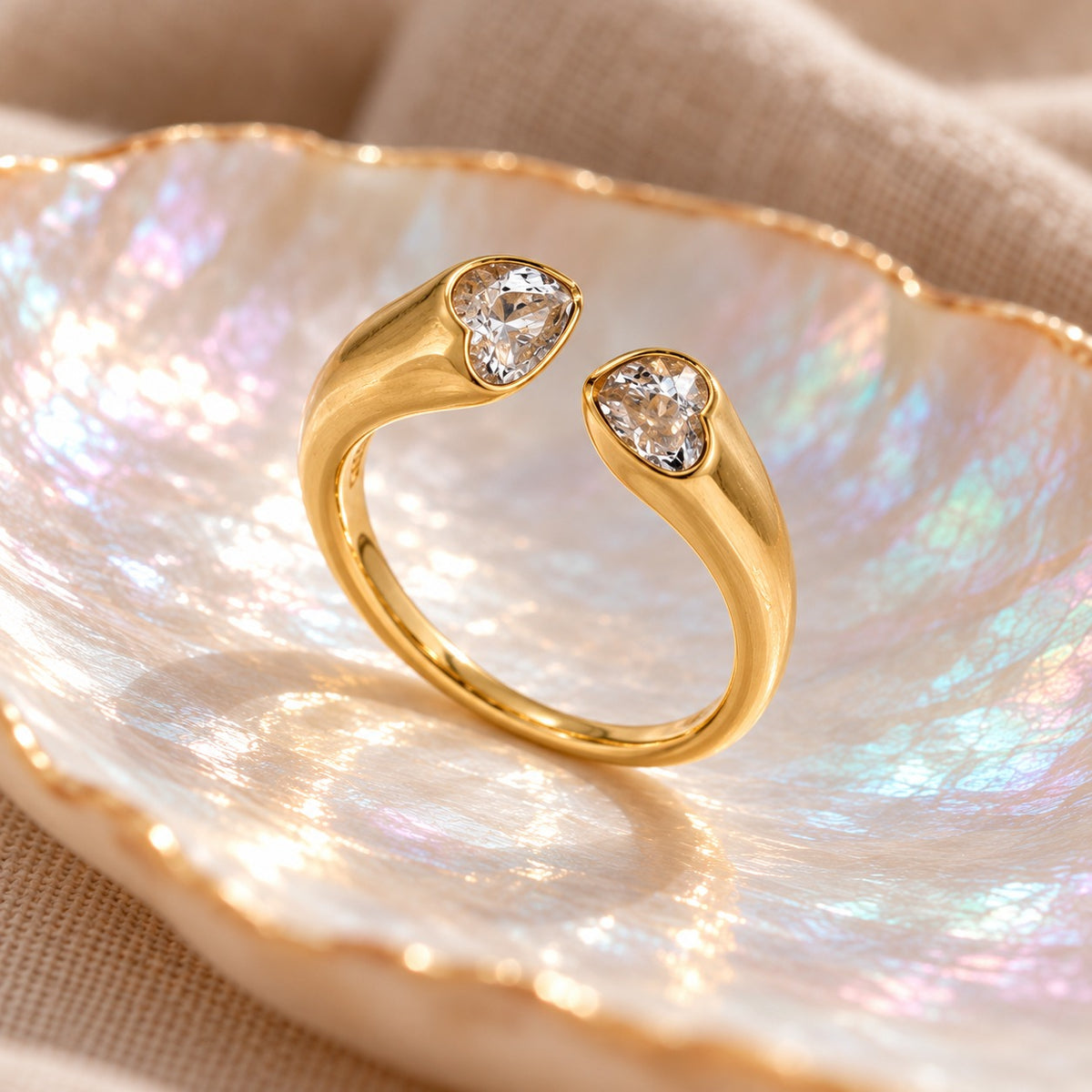 Twin Heart ring standing upright, side view of the heart bezels