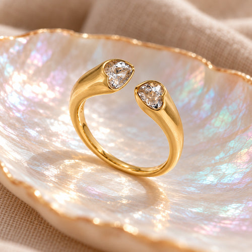 Twin Heart ring standing upright, side view of the heart bezels